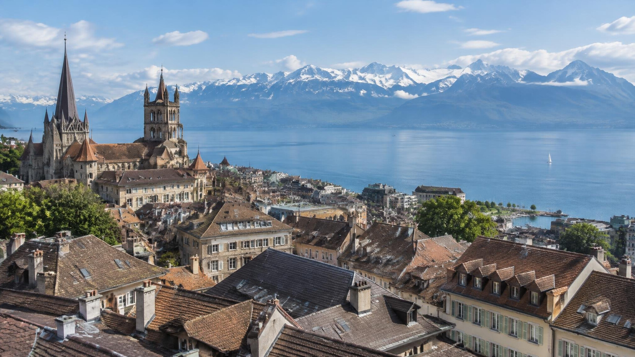 Aerial view of Lausanne old town rooftops beside Lake Geneva